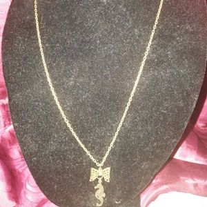 Seahorse with bow long necklace in gold tone